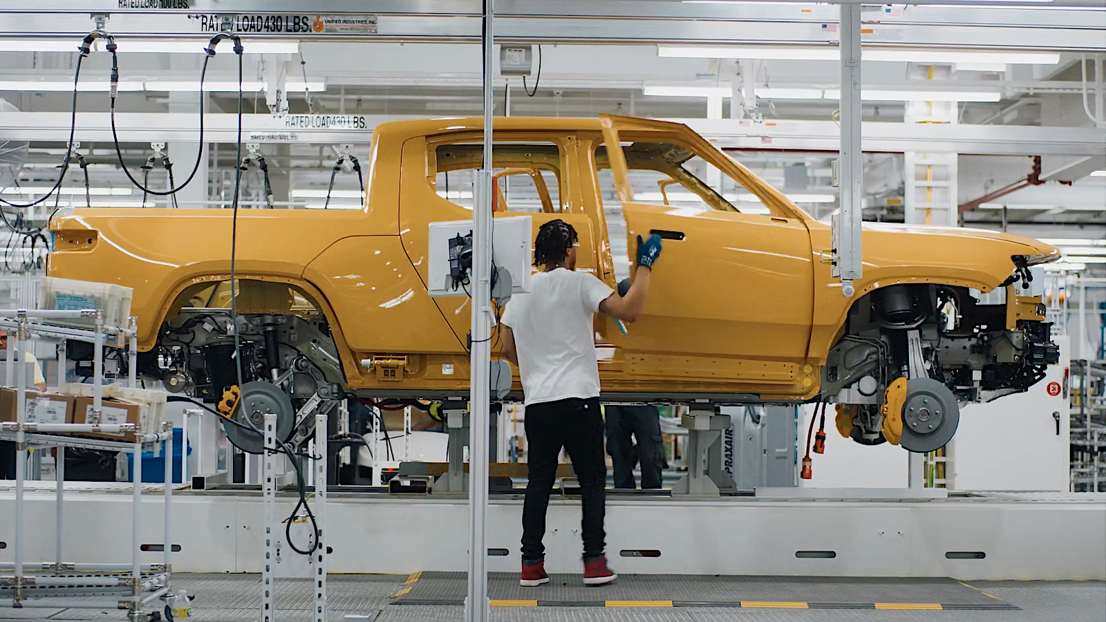 Rivian worker on production line